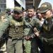 Colombian policemen accompany a Venezuelan police officer who deserted from Venezuela at the Simon Bolivar international bridge, in Cucuta, Colombia after President Nicolas Maduro's government ordered to temporary close down the border with Colombia on February 23, 2019. - Venezuela braced for a showdown between the military and regime opponents at the Colombian border on Saturday, when self-declared acting president Juan Guaido has vowed humanitarian aid would enter his country despite a blockade. (Photo by Luis ROBAYO / AFP)