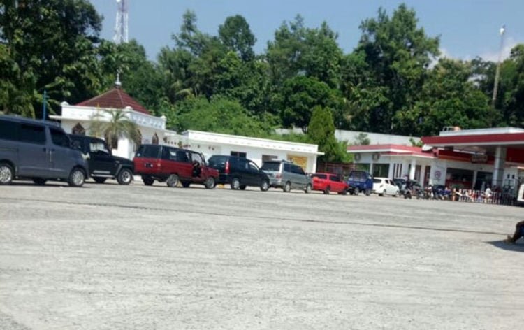 TUNGGU GILIRAN. Antrean panjang kendaraan terjadi di mesin pompa bensin SPBU 21.101.02 di Jalinsum Desa Kekiling, Kecamatan Penengahan, Lampung Selatan, Jumat (28/6). Antrean kendaraan untuk mendapatkan premium diduga milik para pengecor. (LAMPUNG POST/AAN KRIDOLAKSONO)