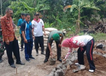 BEDAH RUMAH. Camat Palas, Lampung Selatan, Rika Wati bersama Uspika dan didampingi Pjs Kepala Desa Sukaraja Ridwan secara simbolis  melakukan peletakan batu program bedah rumah di Dusun Simpangpelabuh, Desa Sukaraja, Jumat (18/7). Pemerintah desa setempat melakukan bedah rumah untuk tujuh kepala keluarga. (LAMPUNG POST/ARMANSYAH)