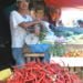 TERUS NAIK. Seorang pedagang sayur-mayur menunggui cabai dagangannya, Minggu (7/7). Harga cabai di sejumlah pasar di Lampung Selatan terus naik menjadi Rp70 ribu per kg. (LAMPUNG POST/AAN KRIDOLAKSONO)