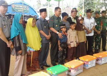 BANTUAN SOSIAL. Ketua Tim Wasev TMMD, Brigjen TNI Amalsyah Tarmizi mendampingi Wakil Bupati Lampung Utara, Budi Utomo, berfoto bersama usai penyerahan secara simbolis bantuan sosial bagi janda dan anak yatim saat meninjau pelaksanaan kegiatan TMMD ke-105 Kodim 0412/LU di lapangan Desa Batunangkop, Kecamatan Sungkai Tengah, Sabtu (20/7). (LAMPUNG POST/YUDHI HARDIYANTO)