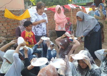 MEMINDAHKAN TEPUNG. Ibu-ibu warga Perumahan Sejahtera RT 08 Dusun III Hajimena, Natar, mengikuti lomba memindahkan tepung di lapangan setempat, Minggu (18/8). Kegiatan digelar dalam rangka memeriahkan HUT ke-74 RI. (LAMPUNG POST/MUHARRAM CANDRA LUGINA)