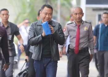 Bupati Lampung Utara Agung Ilmu Mangkunegara (tengah) dikawal petugas saat akan menjalani pemeriksaan, di Gedung KPK, Jakarta, Senin (7/10/2019). Komisi Pemberantasan Korupsi (KPK) menangkap Bupati Lampung Utara, Agung Ilmu Mangkunegara dan mengamankan uang sekitar Rp 600 juta yang diduga terkait dengan proyek di Pemkab Lampung Utara.  ANTARA FOTO/Reno Esnir/ama.