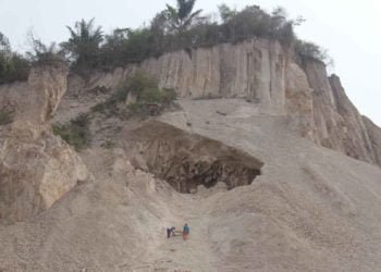 BUKIT RAWAN LONGSOR. Dua pekerja mengumpulkan batu di bawah Gunung Camang di Tanjunggading, Kecamatan Kedamaian, Bandar Lampung, Selasa (12/11). Kegiatan penambangan tersebut sangat berbahaya karena tanpa alat pengaman dan rawan longsor.
n LAMPUNG POST/SUKISNO