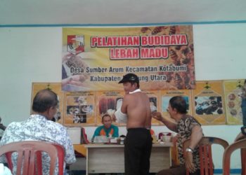 TERAPI LEBAH. Instruktur Pusat Apiari Pramuka Bidang Perlebahan, Sudharto, mempraktikkan terapi sengatan lebah pada peserta saat pelatihan budi daya lebah madu di aula Balai Desa Sumberarum, Kecamatan Kotabumi, Lampung Utara, Sabtu (21/12). LAMPUNG POST/YUDHI HARDIYANTO