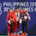 SUMBANG EMAS. Lifter Indonesia peraih emas Rahmat Abdullah (tengah) berfoto dengan peraih perak Tuan Pham dari Vietnam (kiri) dan peraih perunggu Muhammad Erry Hidayat dari Malaysia (kanan). Rahmat merebut emas kelas 73 kg SEA Games Filipina, Rabu (4/12). (TED ALJIBE/AFP)