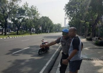 Polisi mengarahkan pejalan kaki menghindari pedestrian Jalan Medan Merdeka Utara, Jakarta Pusat. Medcom.id/Ilham Pratama Putra.