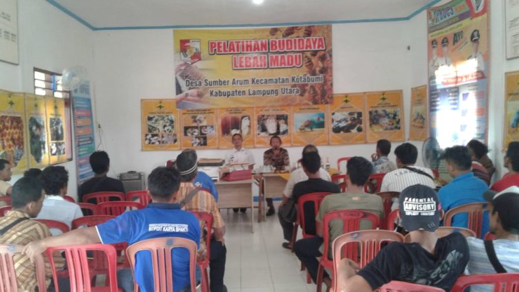 Kepala Desa (Kades) Sumber Arum, Kecamatan Kotabumi, Bintoro, mendampingi pemateri  di pelatihan budidaya lebah madu yang di gelar di aula desa setempat, Rabu (18/12). LAMPUNG POST/YUDHI HARDIYANTO