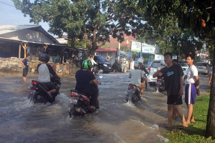 BANJIR DI BANDAR LAMPUNG. Pengendara saat melintasi banjir di Jalan Sultan Agung, Bandar Lampung, Lampung, Jumat (12/6). Banjir tersebut disebabkan tingginya intensitas hujan serta buruknya sistem drainase di sekitar daerah itu dan juga beberapa daerah dikota Bandar Lampung juga terkena dampak banjir.LAMPUNG POST/SUKISNO