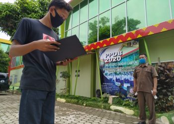 Van 20.48
PENGUMUMAN PPDB DITUNDA. Seorang calon siswa SMAN 5 Bandar Lampung membawa berkas saat akan melihat pengumuman penerimaan peserta didik baru (PPDB) di SMAN 5 Bandar Lampung, Senin (22/6). Dinas Pendidikan dan Kebudayaan (Disdikbud) Lampung menunda pengumuman PPDB SMA. Pengumuman hasil verifikasi data peserta PPDB akan diumumkan paling lambat pukul 23.00, Senin (22/6).
LAMPUNG POST/SUKISNO