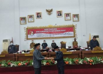 SERAHKAN NOTA. Bupati Tubaba Umar Ahmad menyerahkan nota KUA PPAS APBD Kabupaten Tubaba 2021, kepada Ketua DPRD Tubaba Ponco Nugroho, Selasa (27/10). n LAMPUNG POST/AHMAD SOBIRIN