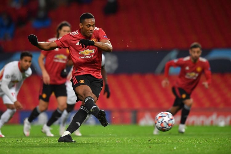 Manchester United's French striker Anthony Martial shoots from the penalty spot to score his team's fourth goal during the UEFA Champions league group H football match between Manchester United and RB Leipzig at Old Trafford stadium in Manchester, north west England, on October 28, 2020. (Photo by Anthony Devlin / AFP)