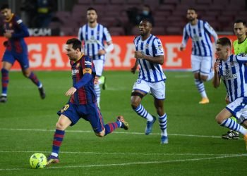 Barcelona's Argentinian forward Lionel Messi runs with the ball during the Spanish league football match between FC Barcelona and Real Sociedad at the Camp Nou stadium in Barcelona on December 16, 2020. (Photo by LLUIS GENE / AFP)
