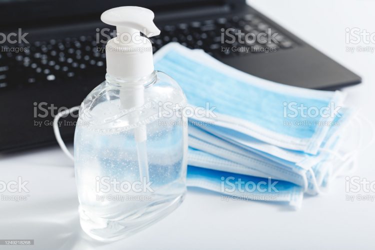 Coronavirus Covid-19 Sars-cov-2 Prevention. Hand sanitizer gel antiseptic, respiratory protective mask,surgical disposable masks protection from viruse on laptop.Remote work, office work,freelance