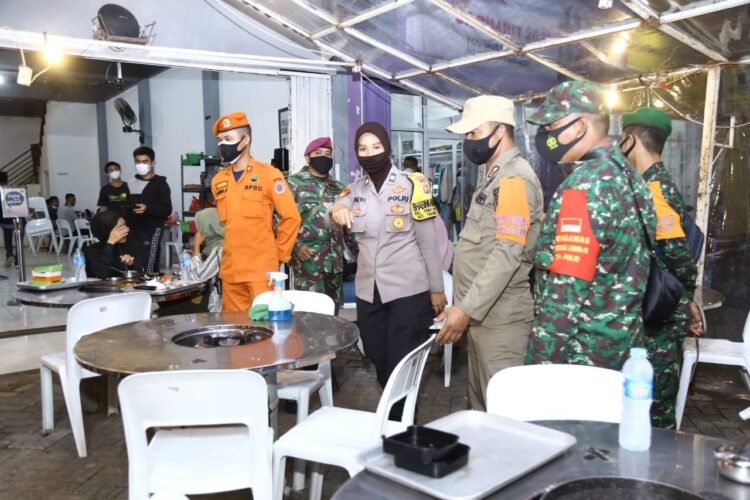 PEMBATASAN OPERASIONAL USAHA. Tim Satgas Penanganan Covid-19 Kota Bandar Lampung mengecek protokol kesehatan di salah satu kafe di Jalan ZA Pagaralam, Bandar Lampung, Rabu (26/1) Malam. Mulai hari ini pemberlakukan pembatasan jam operasional kegiatan usaha di Kota Bandar Lampung.
LAMPUNG POST/ZAINUDDIN