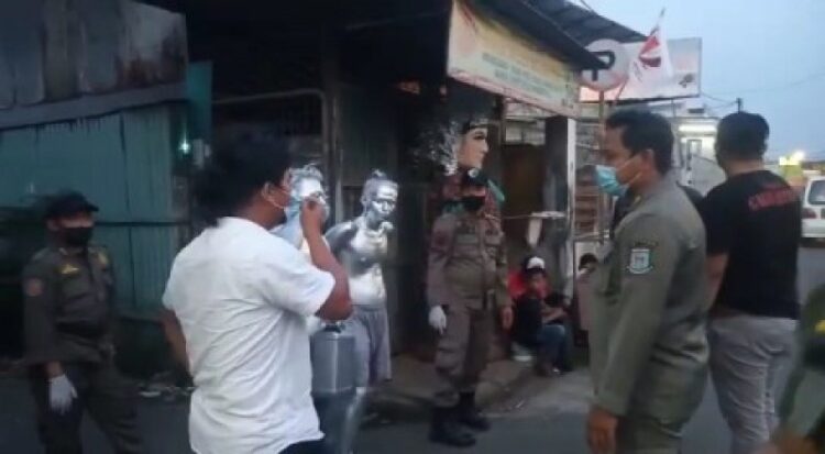 Satuan Polisi Pamong Praja Kota Tangerang Selatan, merazia sejumlah perempatan lampu merah tempat mangkal pengemis modus manusia silver yang telah lama marak di wilayah Tangsel, Selasa 28 September 2021. Foto tangkapan layar
