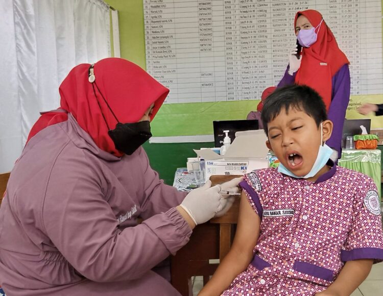 Siswa di di SDN 1 Tanjunggading, Kedamaian, Bandar Lampung sedang menerima suntik vaksin Covid-19, Kamis, (6/1). LAMPUNG POST/UMAR ROBBANI