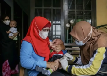 Petugas melakukan imunisasi polio kepada warga secara langsung ke rumah-rumah.