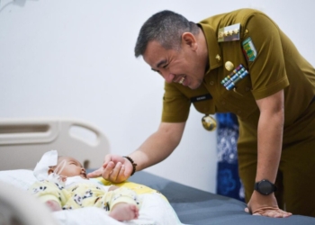 Bupati Pesawaran Dendi Romadhona saat menjenguk bayi tersiram air panas asal Way Khilau saat dirawat di rumah sakit. Dok/Pemkab Pesawaran